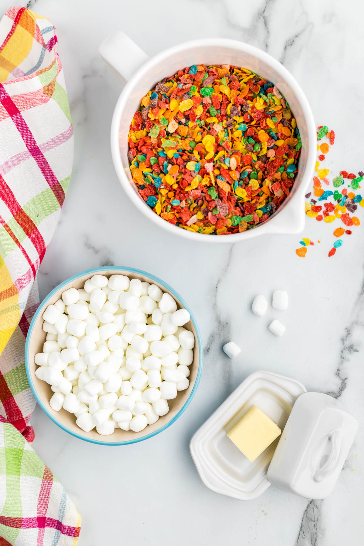 These Fruity Pebble Rice Krispie Treats are a fun and easy snack that even the kids can make! Just takes about 20 minutes! Fruity Pebbles Rice Krispie Treats ingredients in bowls.