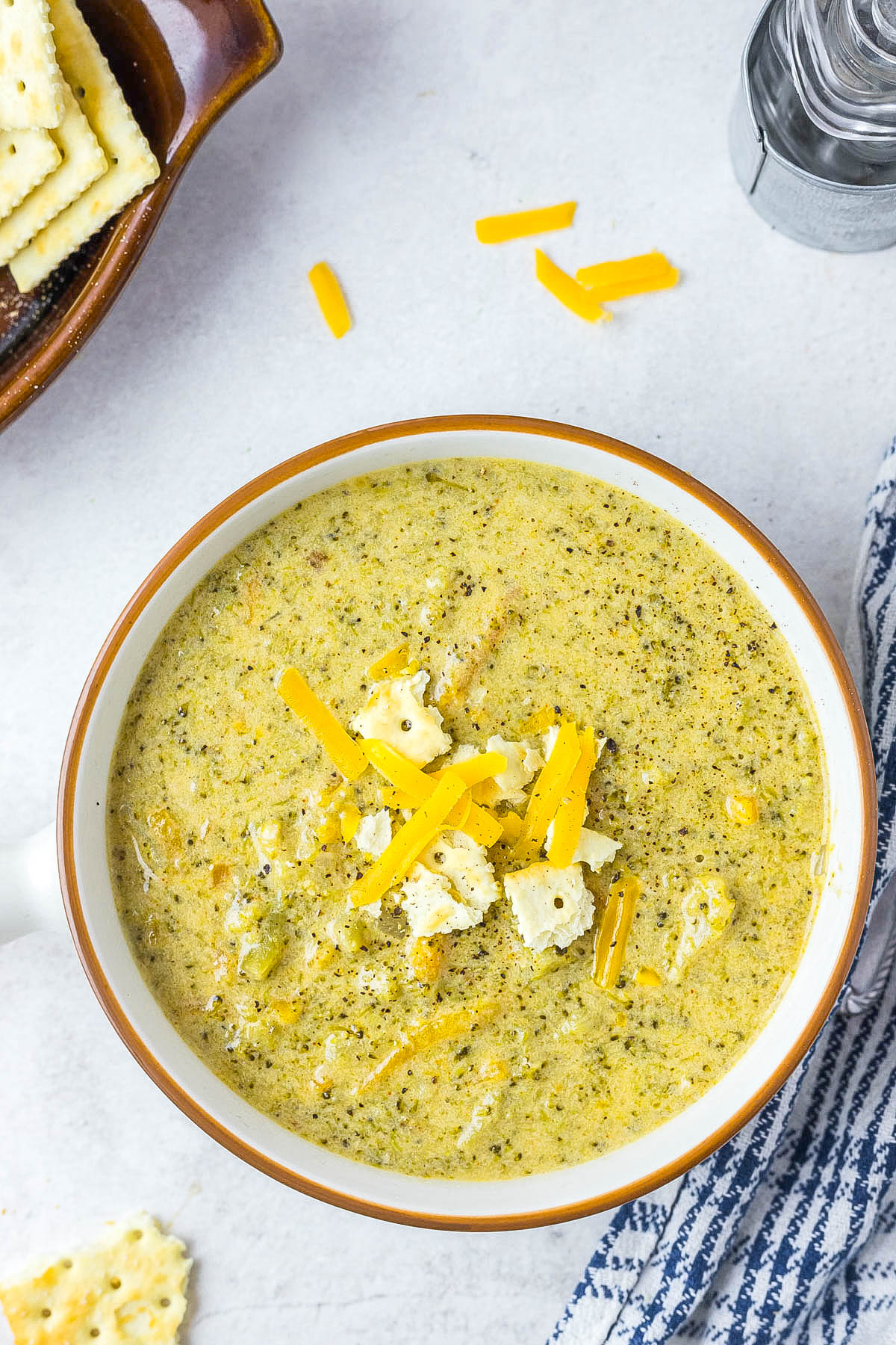 Instant Pot Broccoli Cheddar Soup in white bowl topped with cheese and crackers. Instant Pot Broccoli Cheddar Soup in white bowl topped with cheese and crackers.