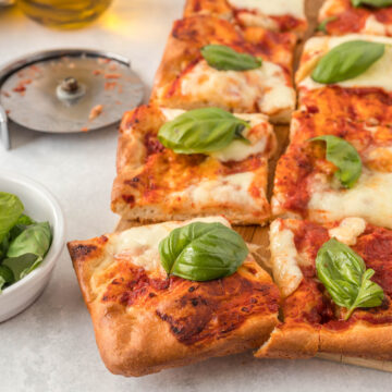 Sheet Pan Margherita Pizza topped with fresh basil.