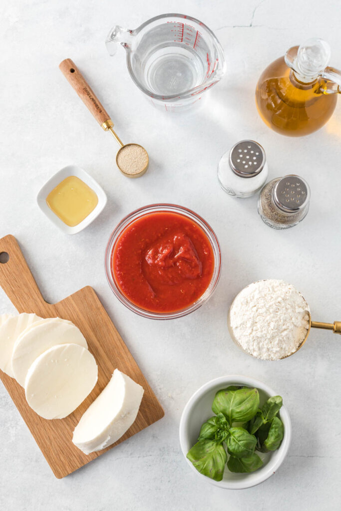 This easy Sheet Pan Margherita Pizza will be your go-to for pizza night! Sheet Pan Margherita Pizza Ingredients in bowls on white back ground.