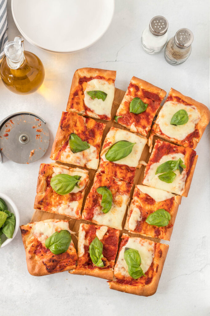 This easy Sheet Pan Margherita Pizza will be your go-to for pizza night! overhead view of Sheet Pan Margherita Pizza with basil.