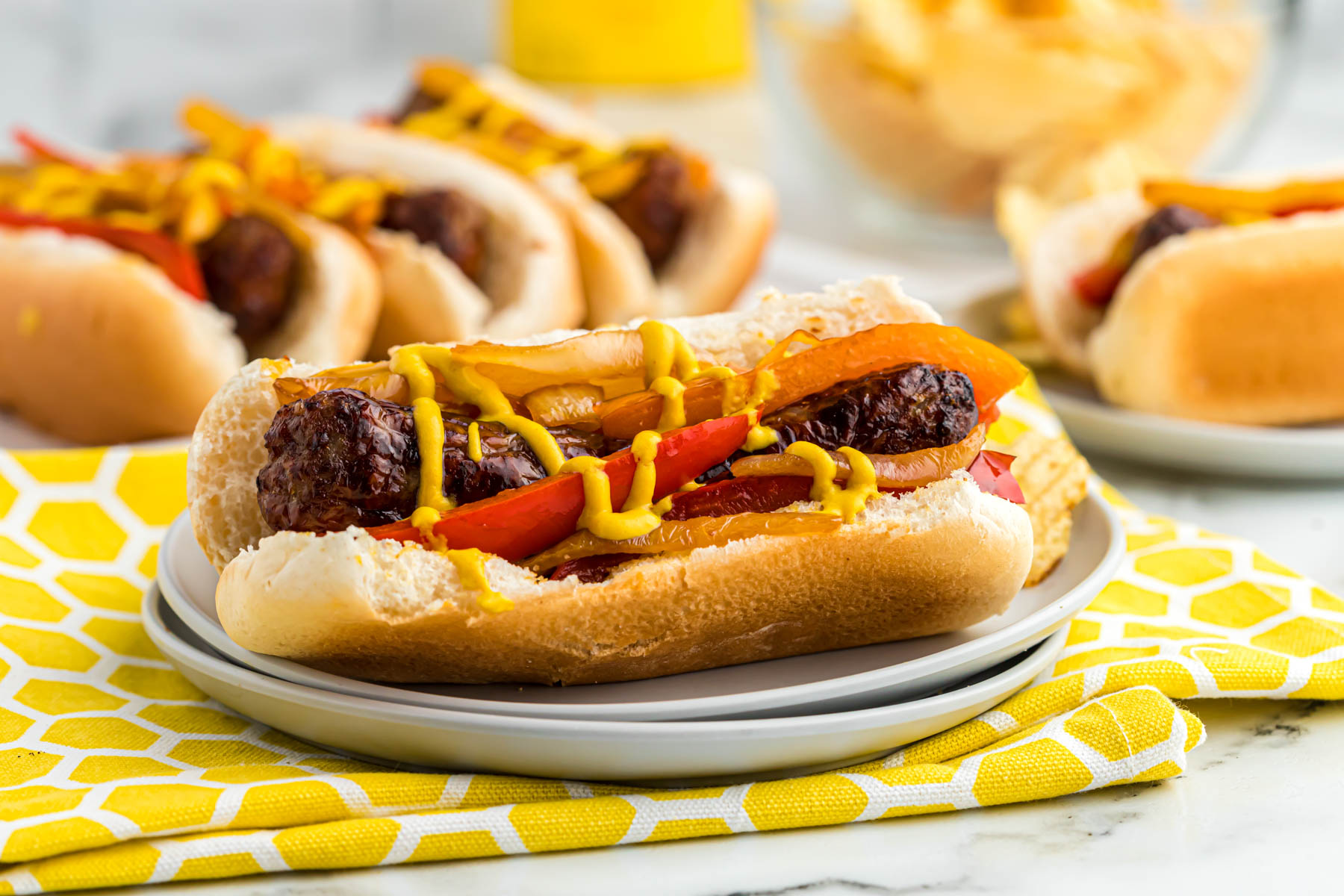bratwurst on bun topped with mustard.