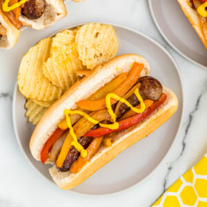 bratwurst on plate with chips.