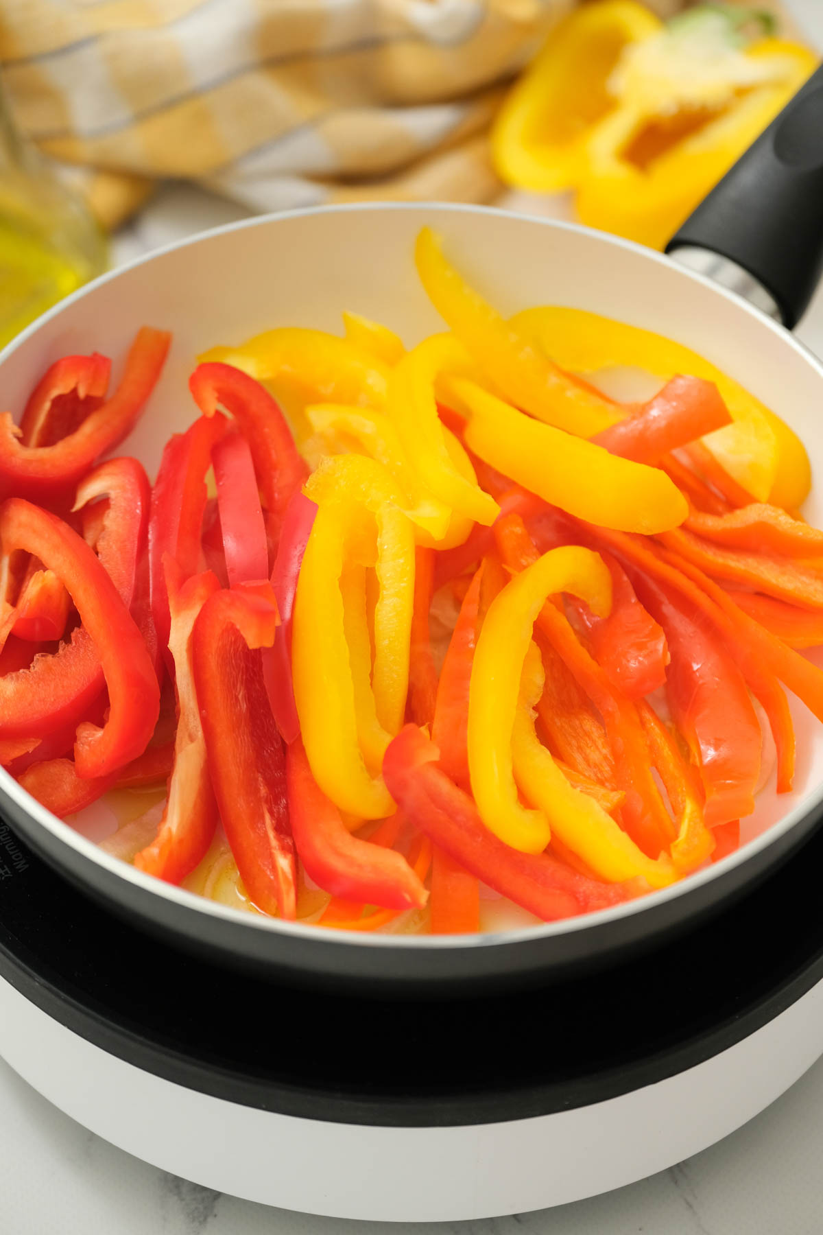 peppers cooking in pan.