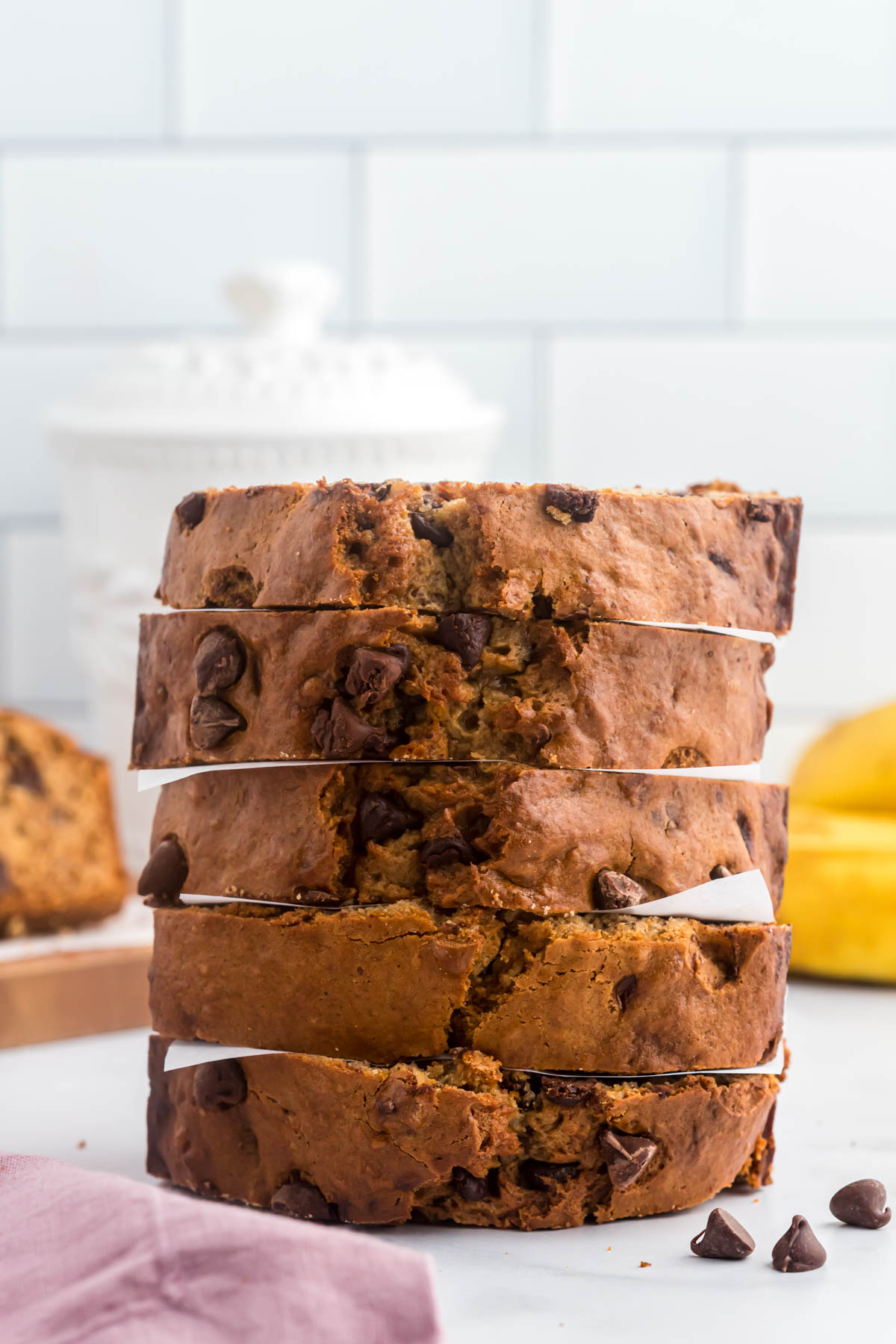 This Banana Chocolate Nut Bread is an easy and delicious quick bread! A one bowl recipe, loaded with nuts and chocolate chips! pieces of bread stacked.