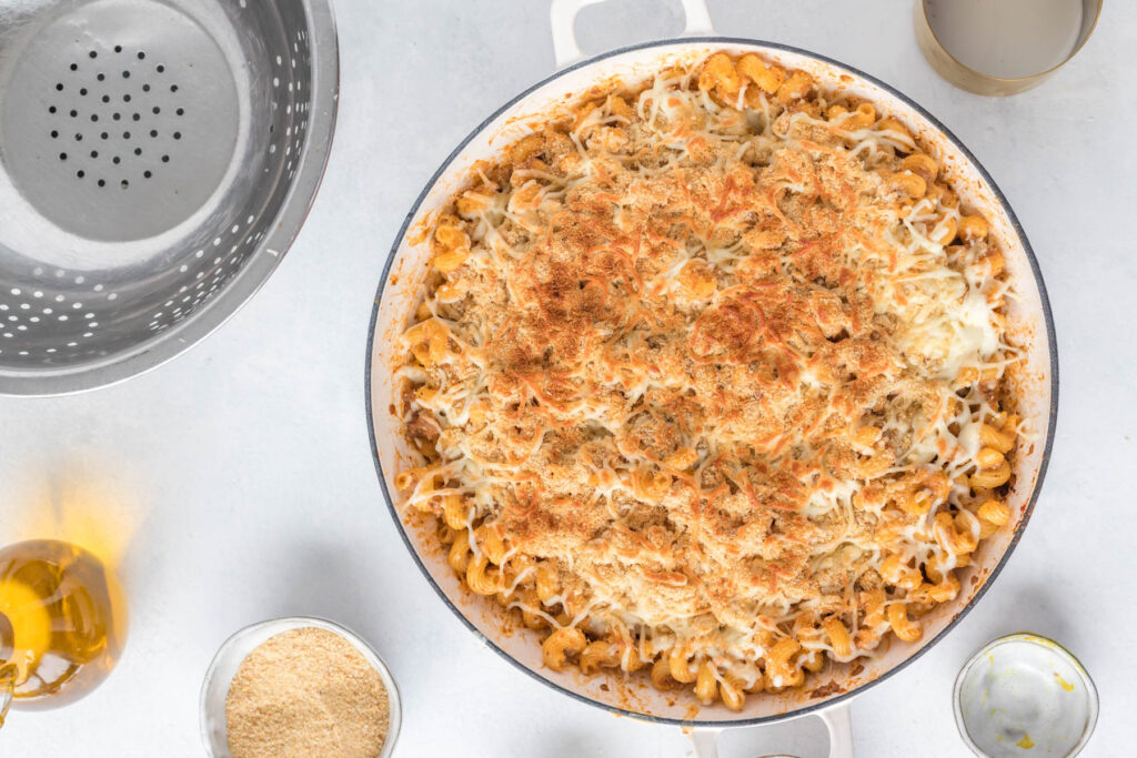 pasta casserole topped with cooked bread crumbs and cheese.