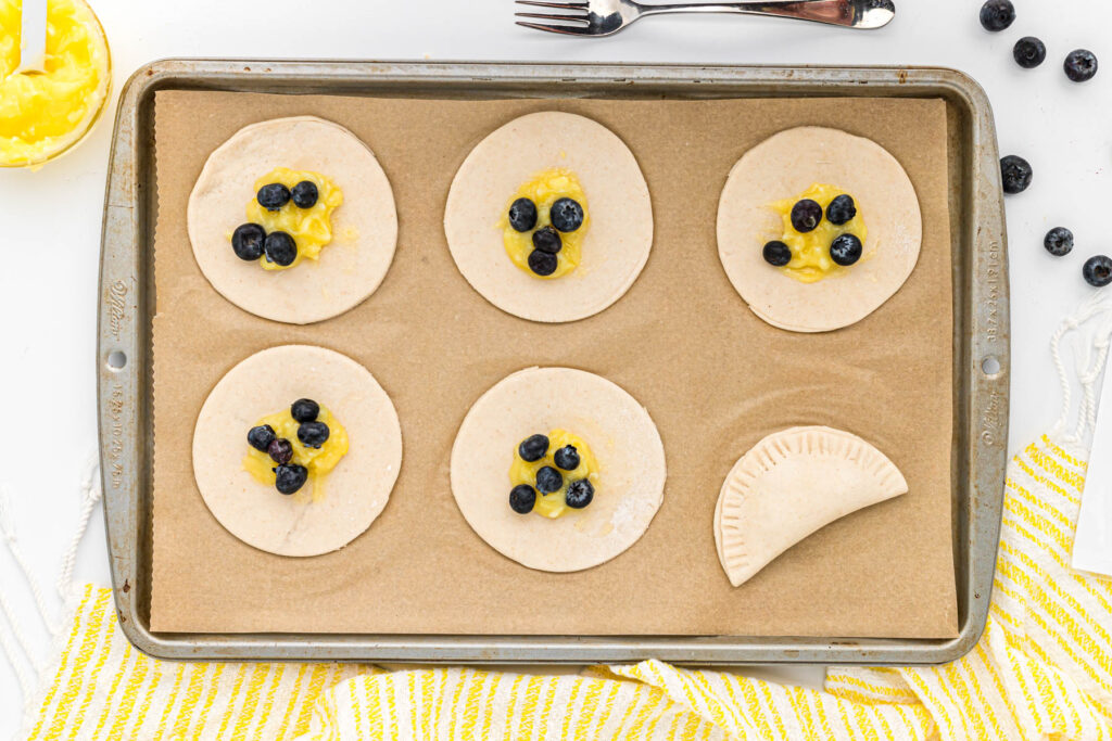 uncooked turnovers on parchment paper.