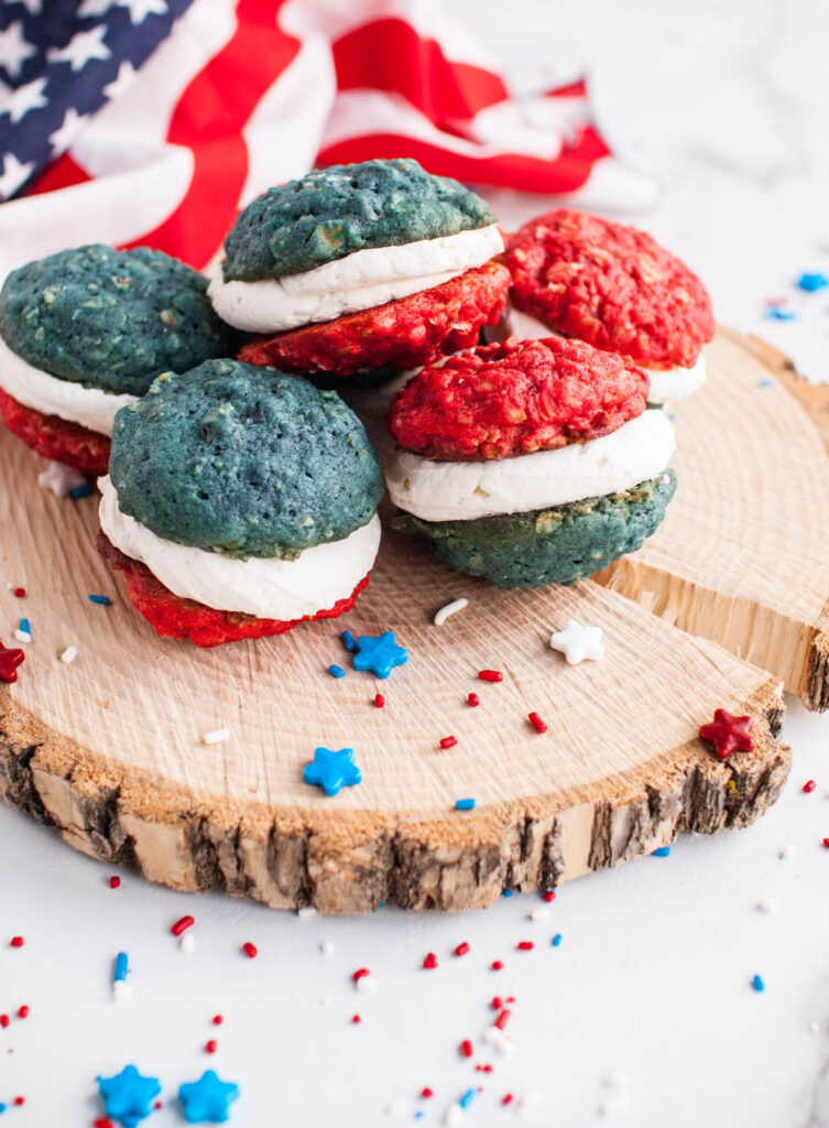 These Oatmeal Cookie Sandwiches are a fun holiday treat! Soft, chewy cookie filled with a sweet buttercream frosting! Oatmeal Cookie Sandwiches on wooden background.