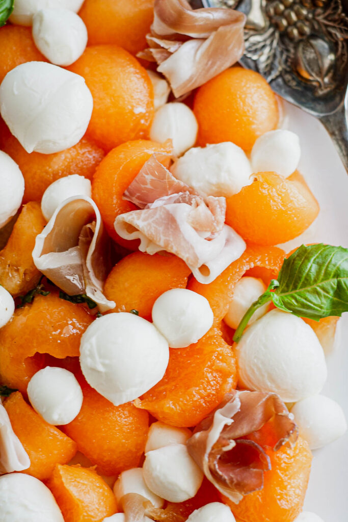Easy and fresh, Melon Prosciutto Salad! Sweet cantaloupe combined with prosciutto topped with a lemon basil vinaigrette, perfect for summer!