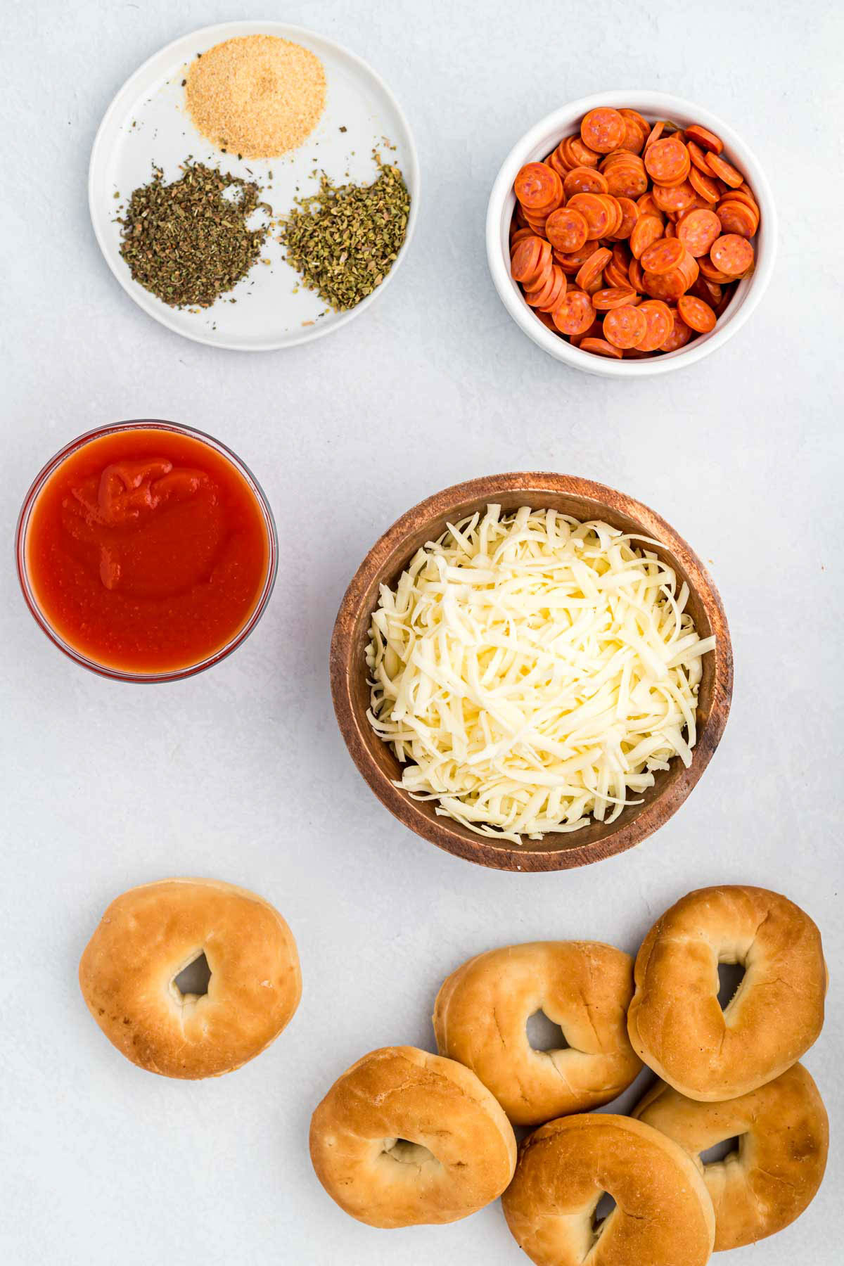 Easy Air Fryer Bagel Bites! These pizza flavored bites could not be easier! Made with a few ingredients that makes the best lunch or snack! ingredients for Air Fryer Bagel Bites on white background.