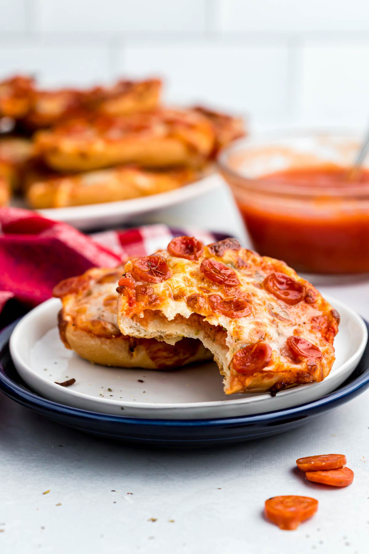 Easy Air Fryer Bagel Bites! These pizza flavored bites could not be easier! Made with a few ingredients that makes the best lunch or snack! air fryer bagel bites with bite marks.