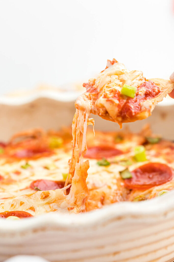pulling cheese out of baking dish.