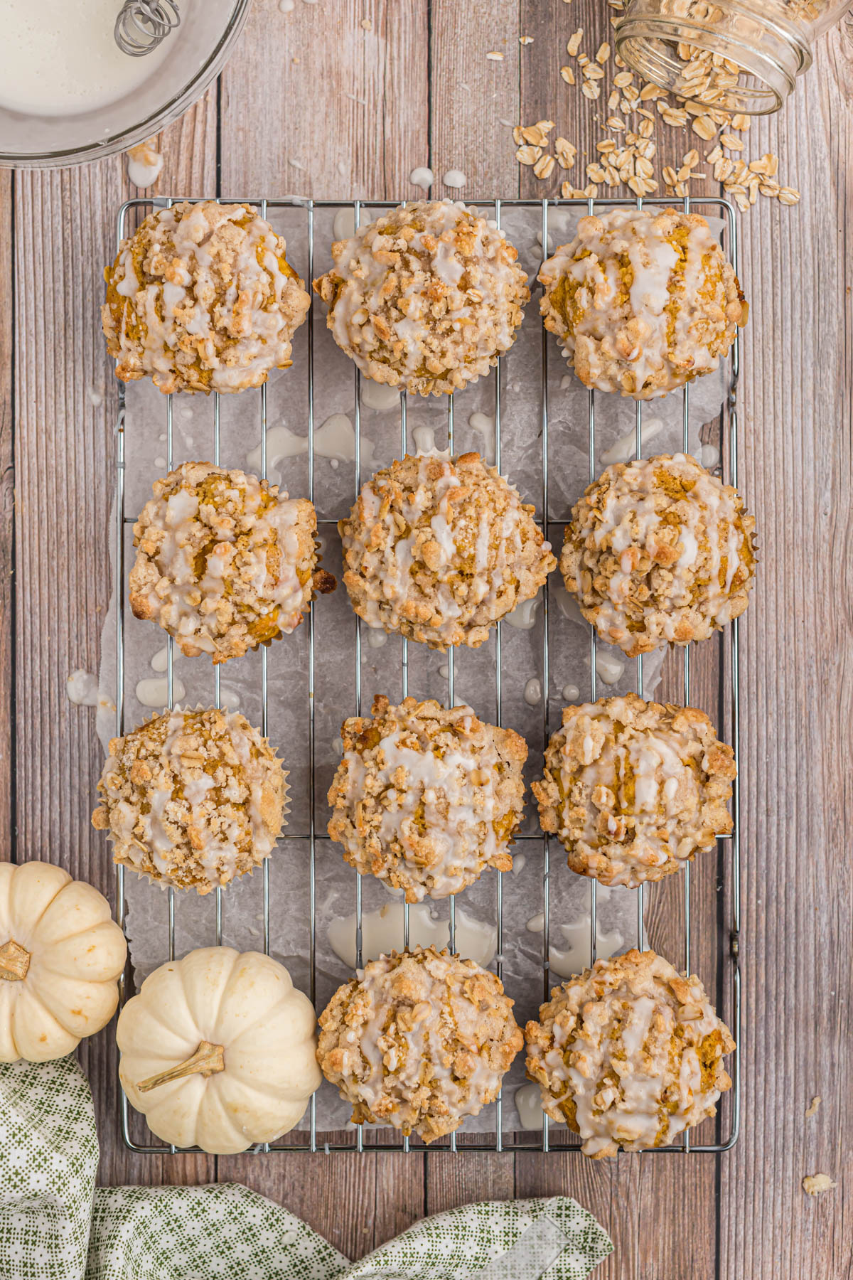 Fall inspired muffins that are perfect for a busy morning! These Pumpkin Oatmeal Muffins will not disappoint! They are so delicious! overhead of muffins on cooling rack.