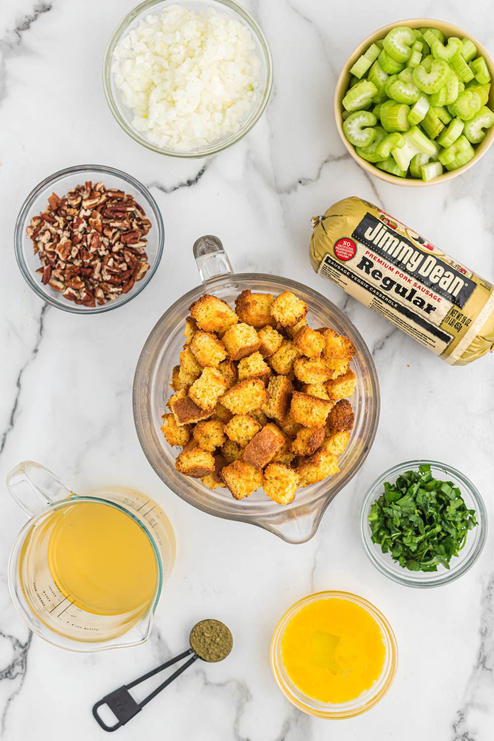 Savory sausage cornbread stuffing, with lots of flavor, seasonings and versatile for any meal with a little added crunch of pecans! ingredients for easy Sausage Cornbread Stuffing.