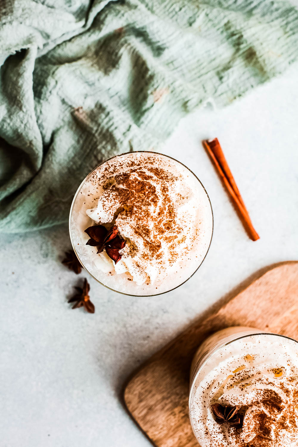 This easy eggnog frappuccino is the perfect copycat coffee shop version that's made right at home! Creamy and delicious! overhead view of Eggnog Frappuccino in cup topped with ground cinnamon.