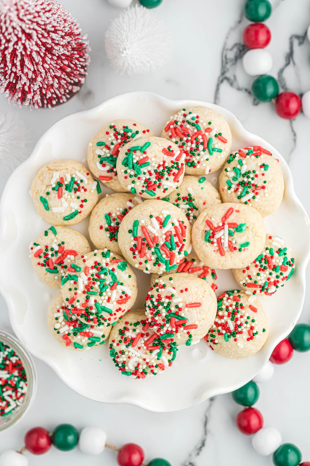 These easy Vanilla Christmas Cookies will be a favorite during the holiday season! With simple ingredients, even the kids can make them! vanilla cookies stacked on white plate.