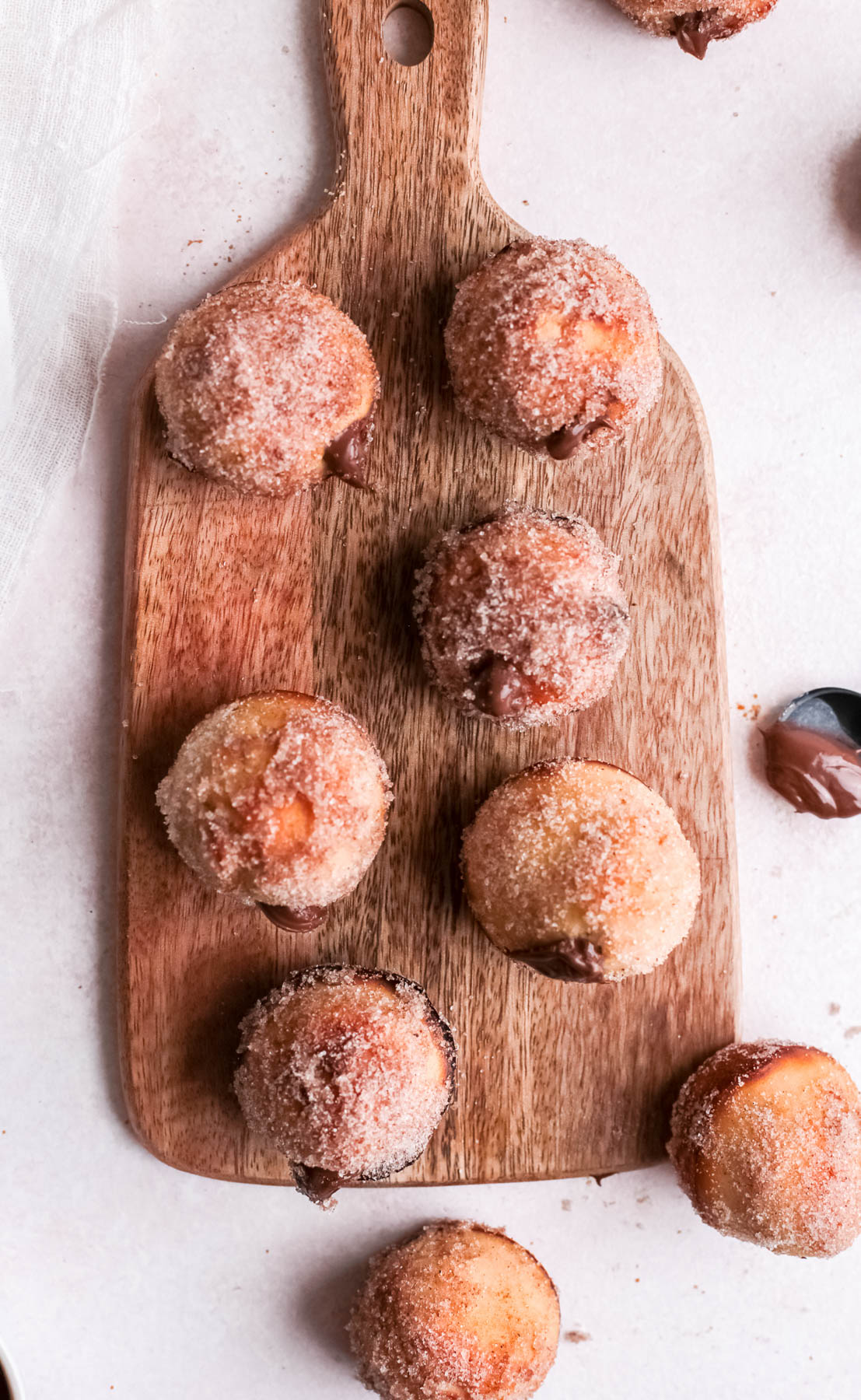 Indulge in a bite of heaven with our delicious Nutella donut holes recipe. These baked treats are easy to make and perfect for any day. overhead view of donut holes.