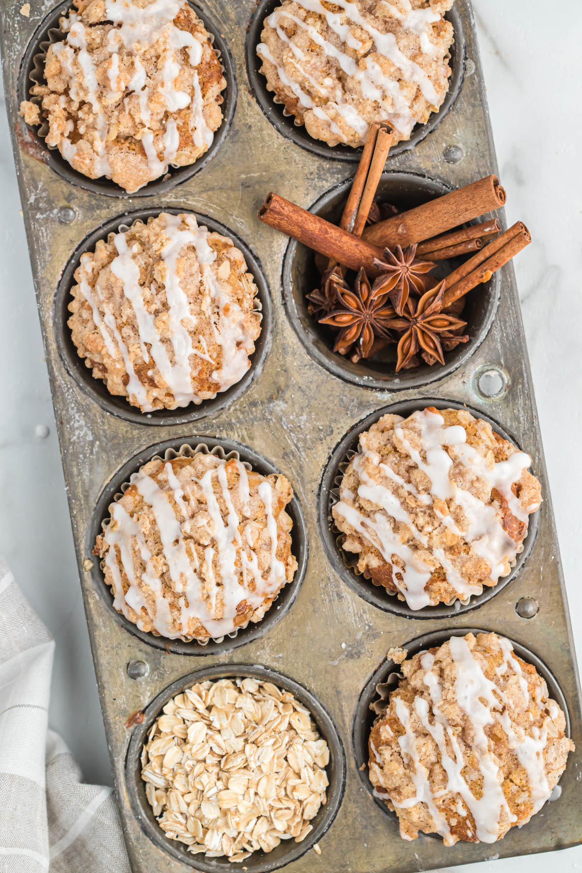 A delicious way to start the day is with these Apple Cinnamon Oatmeal Muffins. They are moist, slightly sweet and full of flavor! apple oatmeal muffins in muffin tins