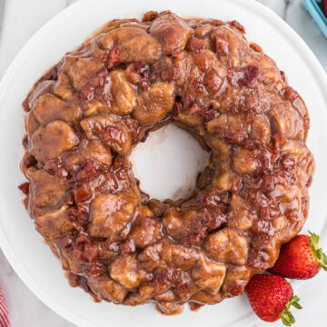 overhead view of strawberry monkey bread on white plate.