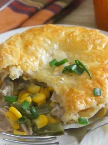 Leftover Turkey Puff Pastry Pot Pies on white plate with fork.