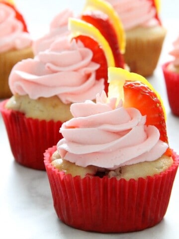 Strawberry Lemon Cupcakes with red cupcake liner on white background