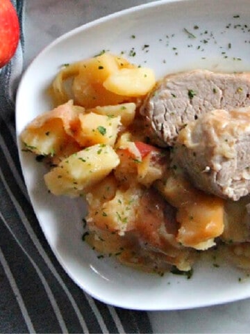 Instant Pot Pork Tenderloin with Apples and Onions on white plate