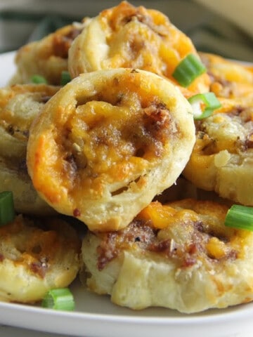 Puff Pastry Sausage Cheddar Pinwheels on white plate