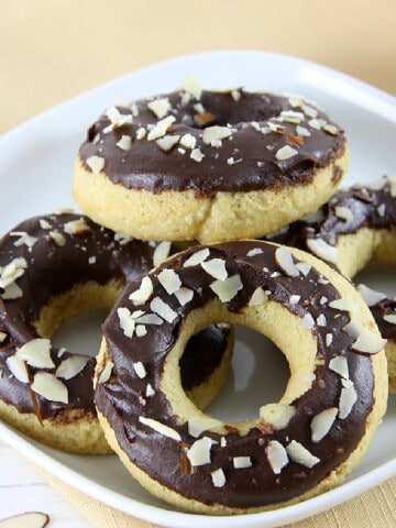 Chocolate Almond Glazed Donuts on white plate