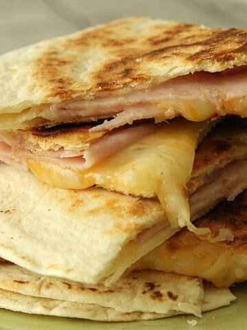 Ham and Cheese Quesadillas stacked on green plate