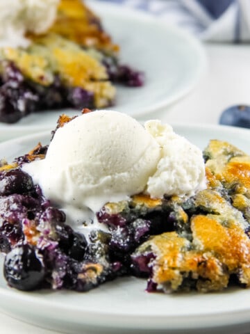 Blueberry Cobbler on white plate with ice cream
