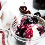 Easy Cherry Compote on ice cream in glass bowl