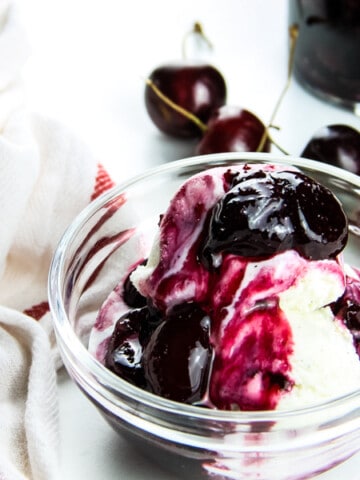 Easy Cherry Compote on ice cream in glass bowl