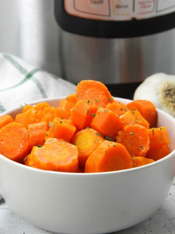 Instant Pot Carrots in gray bowl with green and white napkin