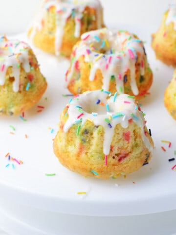 Funfetti Mini Bundt Cakes with 6 cakes on white cake plate