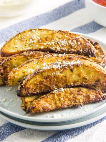 Air Fryer Parmesan Potato Wedges on white plate.