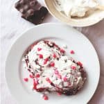Red Velvet Cinnamon Rolls on plate with sprinkles