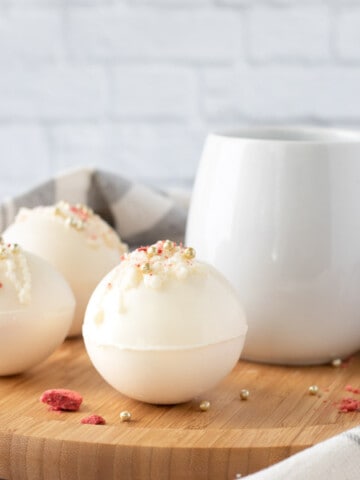 Strawberry Hot Cocoa Bombs on brown board
