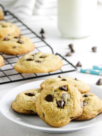 cookies on plate with chocolate chips in background.