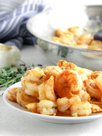 spicy garlic thyme shrimp on white plate