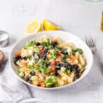 Greek Pasta Salad topped with cheese.
