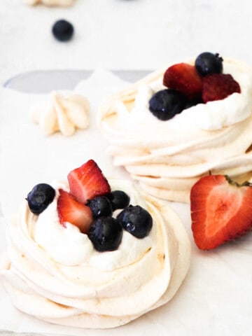 Mini Berry Meringue with fresh berries on top.
