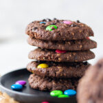 Double Chocolate Monster Cookies stacked on top of each other.