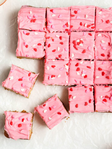 Strawberry Frosted Cookie Bars cut into squares.