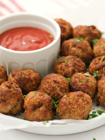 Air Fryer Turkey Meatballs on white plate with sauce.
