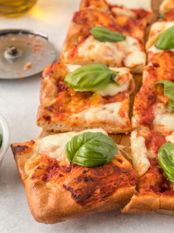 Sheet Pan Margherita Pizza topped with fresh basil.