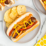 bratwurst on plate with chips.