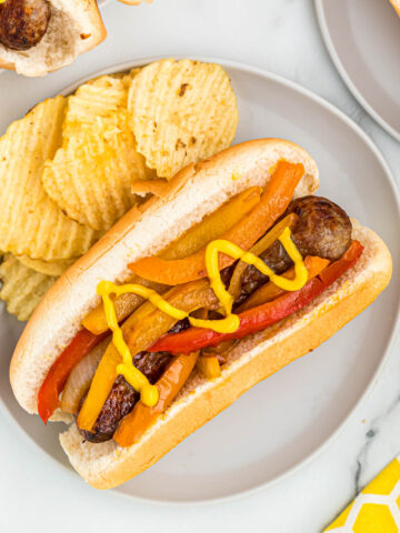 bratwurst on plate with chips.