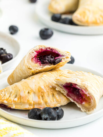 Lemon Blueberry Turnovers cut open on plate.