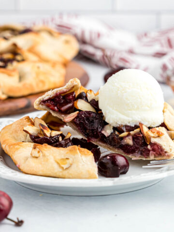 Mini Cherry Almond Galettes topped with ice cream cut in half.