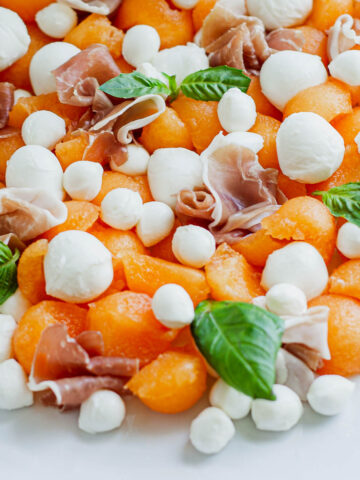 Melon Prosciutto Salad on white plate.